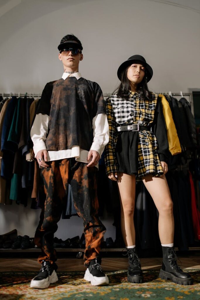 Woman in Black Yellow and White Long Sleeve Dress Standing beside a Man in Black and White Long Sleeve Shirt